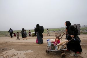 Displaced Iraqi people from different areas in Mosul flee their homes to reach safe areas, after clashes broke out as Iraqi forces battle with Islamic State militants in the city of Mosul, Iraq, March 17, 2017. REUTERS/Youssef Boudlal