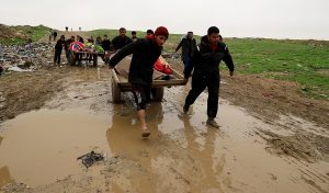 Iraqi men pull carts loaded with the bodies of civilians killed in air strikes, during a battle between Iraqi forces and Islamic State militants, in Mosul, Iraq March 17, 2017. REUTERS/Thaier Al-Sudani